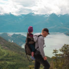 dad hiking with small child on back
